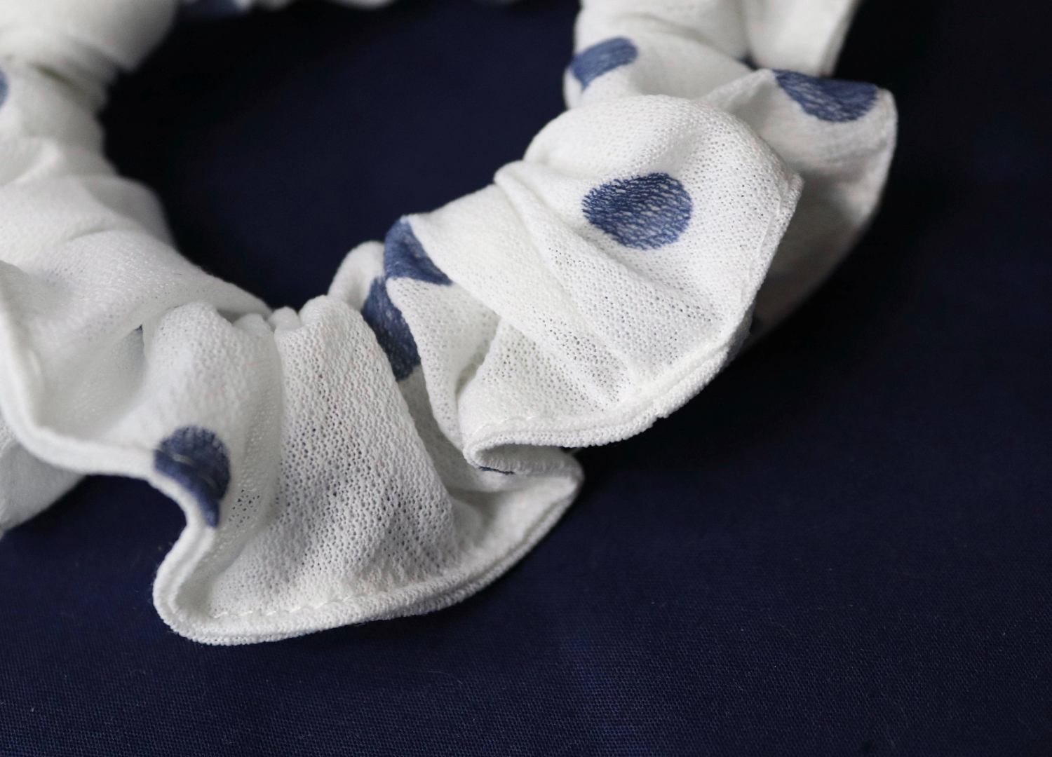 lightweight white polka dot skinny scrunchie close up